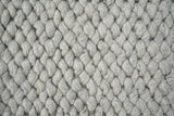 Full view of grey wool rug in natural light