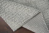 Grey chunky wool rug styled with neutral decor