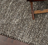 Charcoal brown wool rug styled in a modern living room