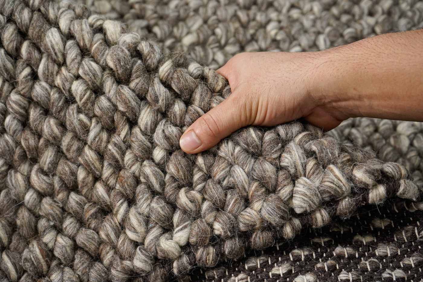 Charcoal brown chunky looped wool rug, flat lay view