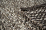 Textured pile close-up of charcoal brown wool rug