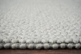 Grey wool rug in a cozy bedroom setting