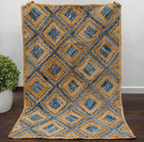 Blue braided jute rug styled in living room