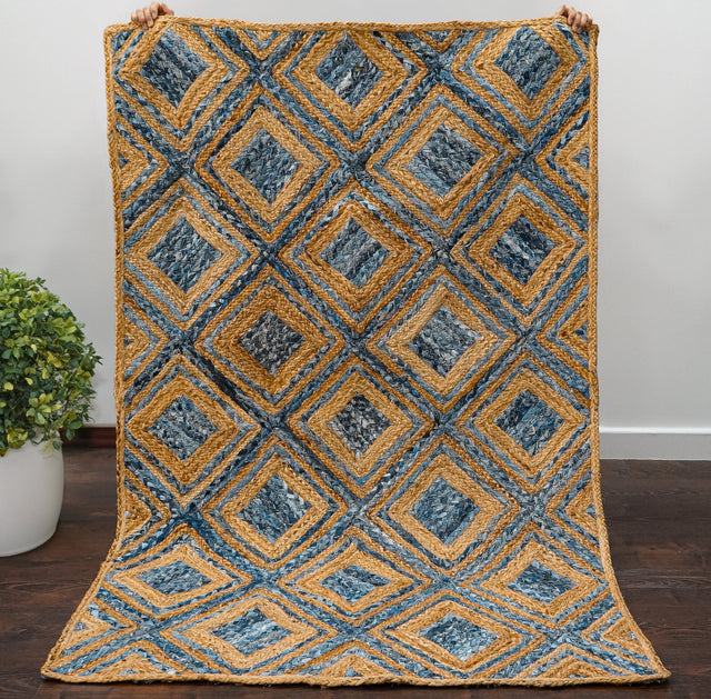 Blue braided jute rug styled in living room