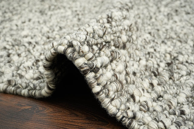 Grey rug styled in living room