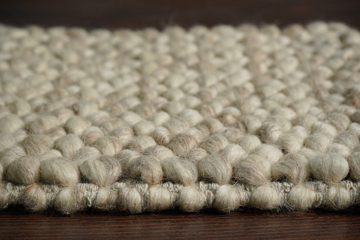 Beige chunky rug styled in a living room