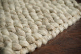 Overhead view of beige chunky wool rug