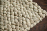 Colour detail of beige felted wool rug