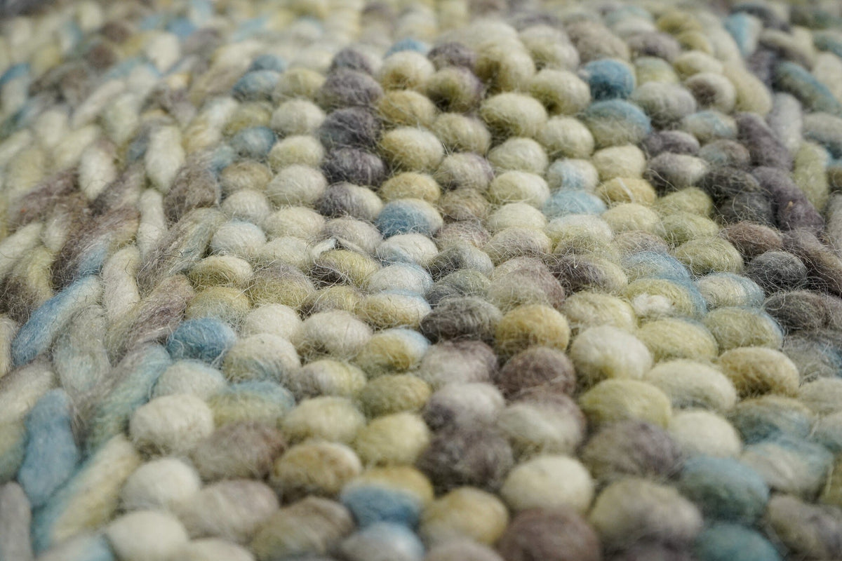Multi colour wool rug styled in a living room