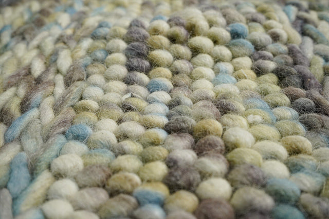 Multi colour wool rug styled in a living room