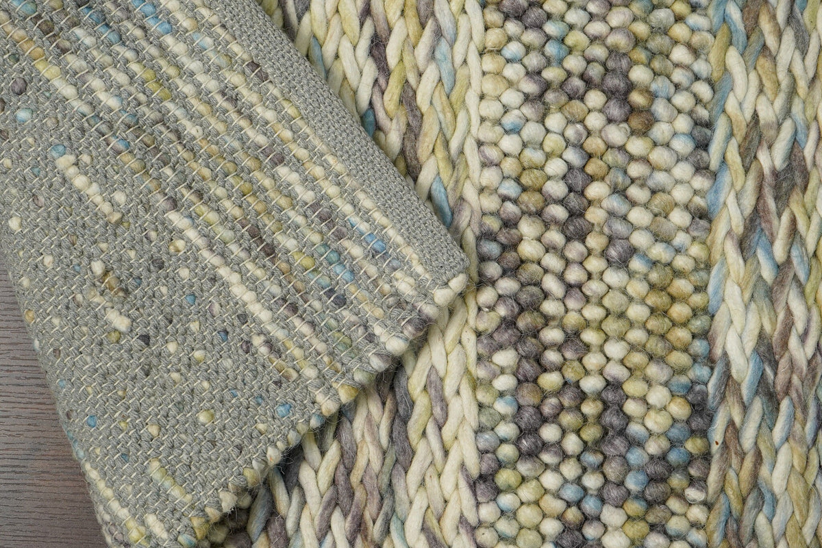Multi colour wool rug in a bedroom setting