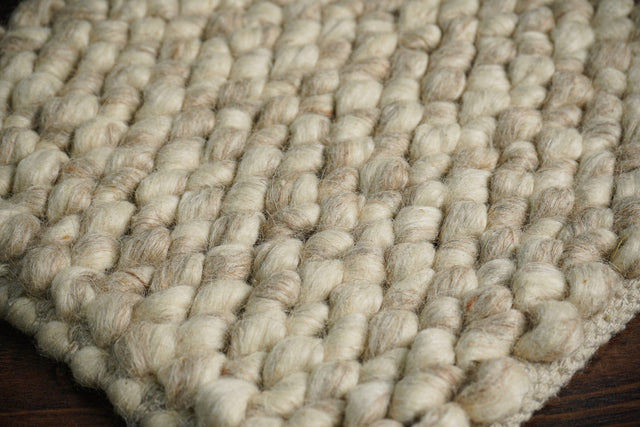 Beige chunky loop wool rug, full flat view