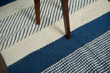 Bohemian blue wool rug in bedroom setting