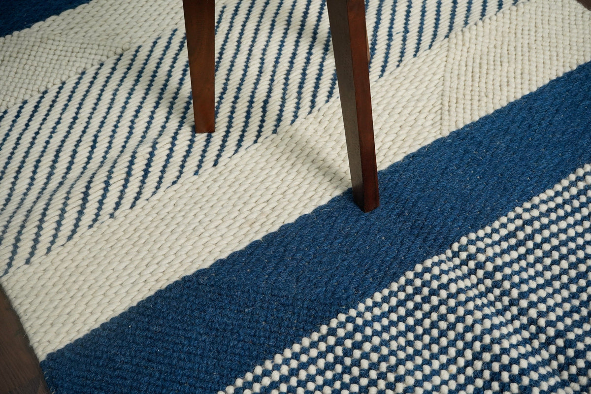 Bohemian blue wool rug in bedroom setting