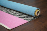 Rainbow striped rug in nursery setting