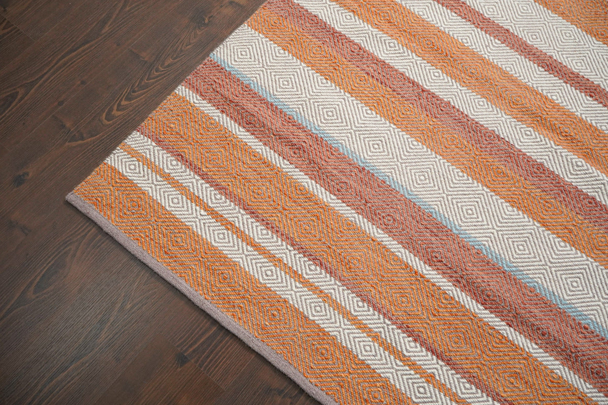 Full flat lay of striped orange kilim rug