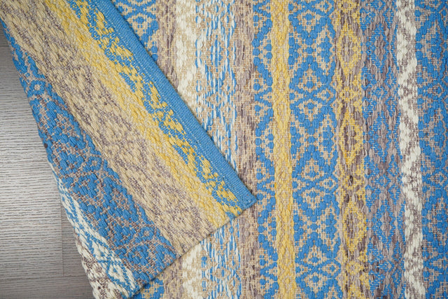 Blue and yellow kilim rug styled in a living room