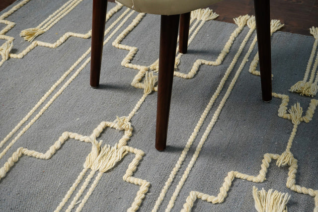 Gray bohemian tasseled wool rug, full flat view