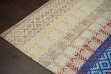 Beige striped rug styled in nursery room