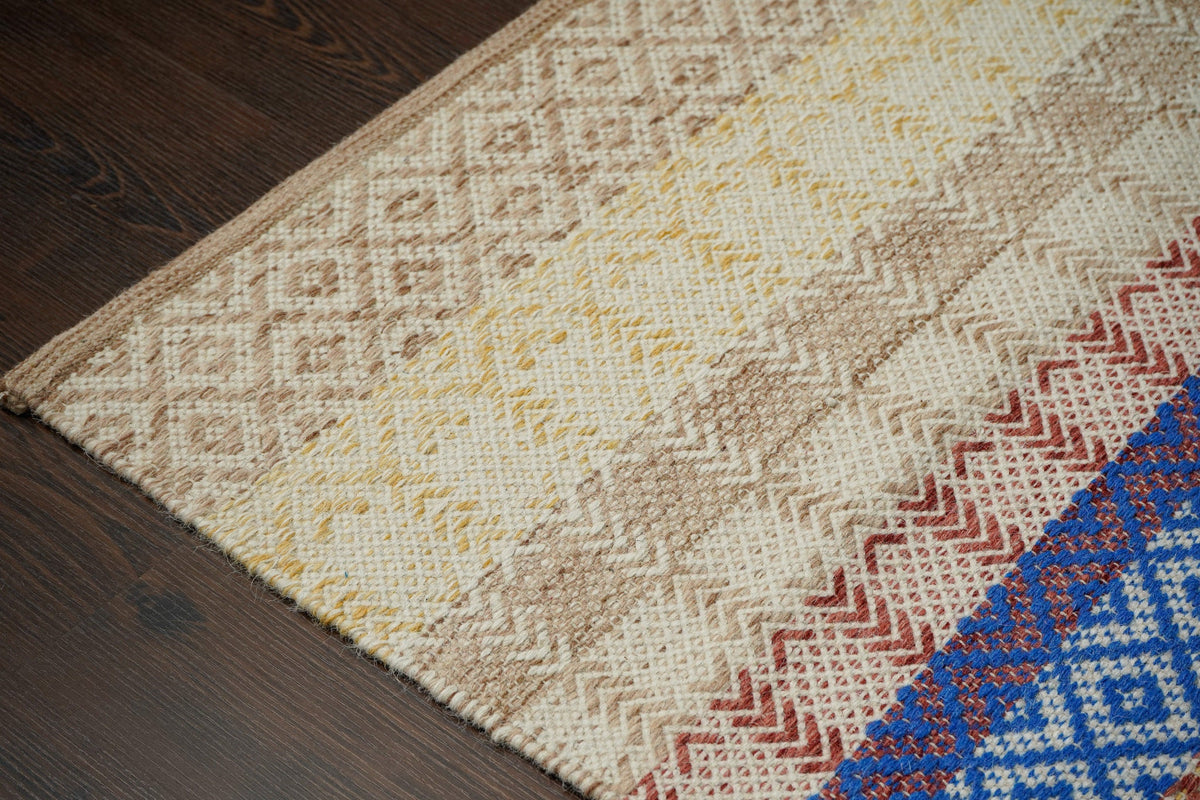 Beige striped rug styled in nursery room