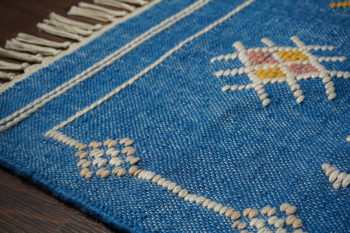Blue patio rug shown at an alternate angle