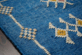 Blue patio rug edge and fringe detail
