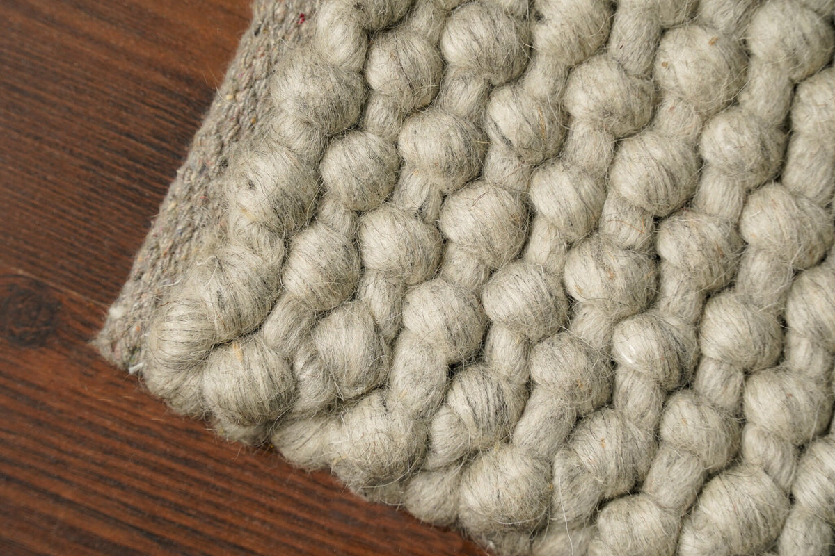 Grey wool rug corner and edge detail
