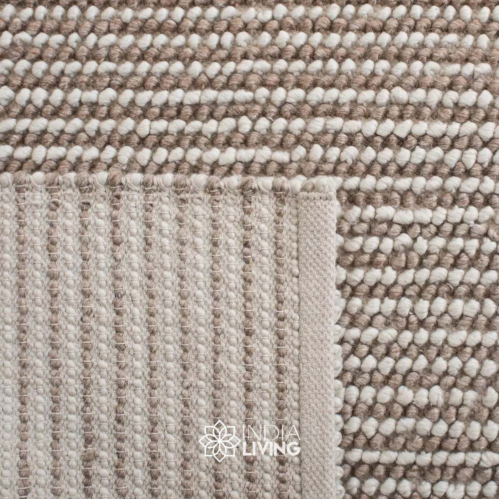Ivory wool rug styled in a Scandinavian living room