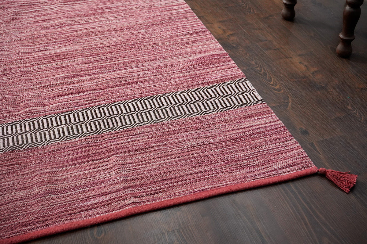 Pink rug placed under living room furniture