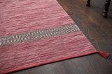 Pink rug placed under living room furniture