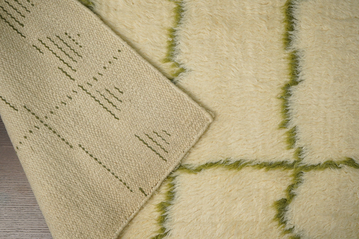 Green Moroccan rug in a bedroom setting