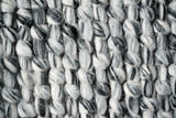 Grey mixture loop chunky wool rug in bedroom setting