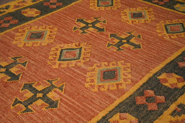 Orange kilim rug styled in living room