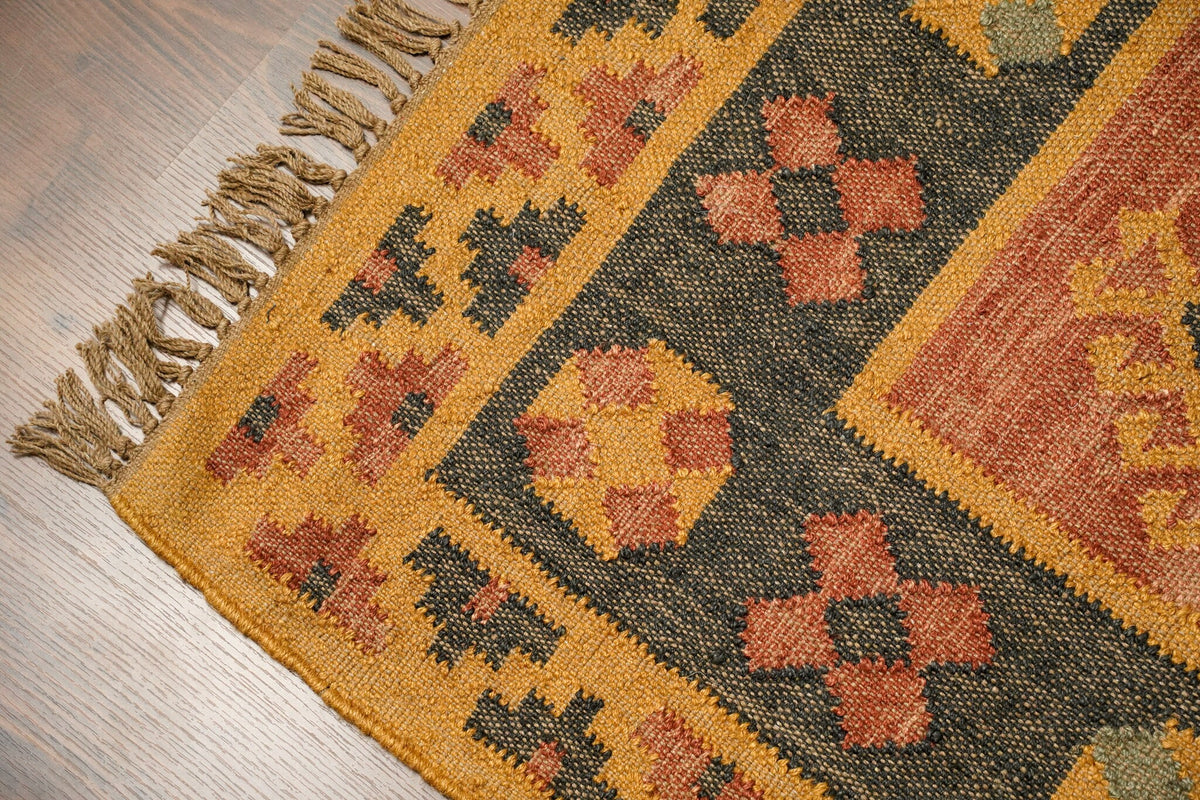 Full flat lay of orange Navajo kilim rug