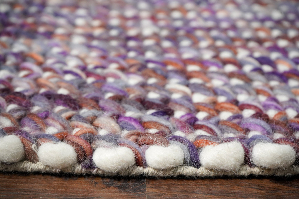 Handwoven purple wool rug edge and border detail