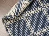 Blue geometric wool rug styled in a living room