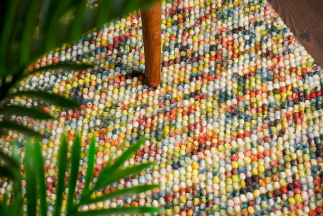 Rainbow chunky loop wool rug, flat lay view
