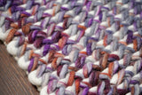 Purple wool rug under a coffee table lifestyle shot