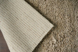 Beige wool rug corner edge detail
