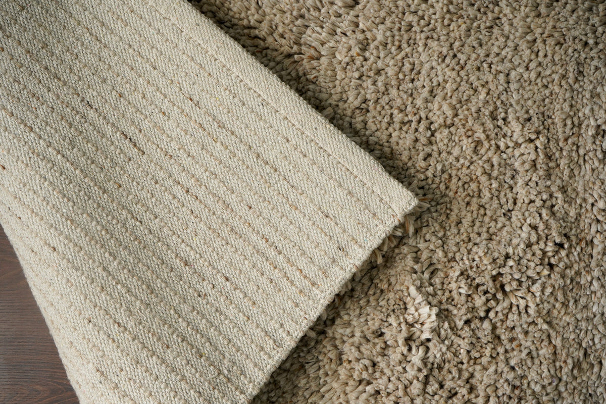 Beige wool rug corner edge detail