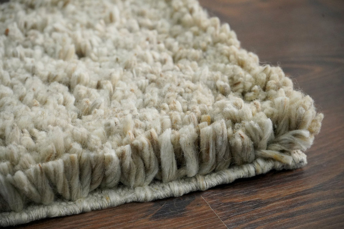Full flat lay of beige shaggy wool rug