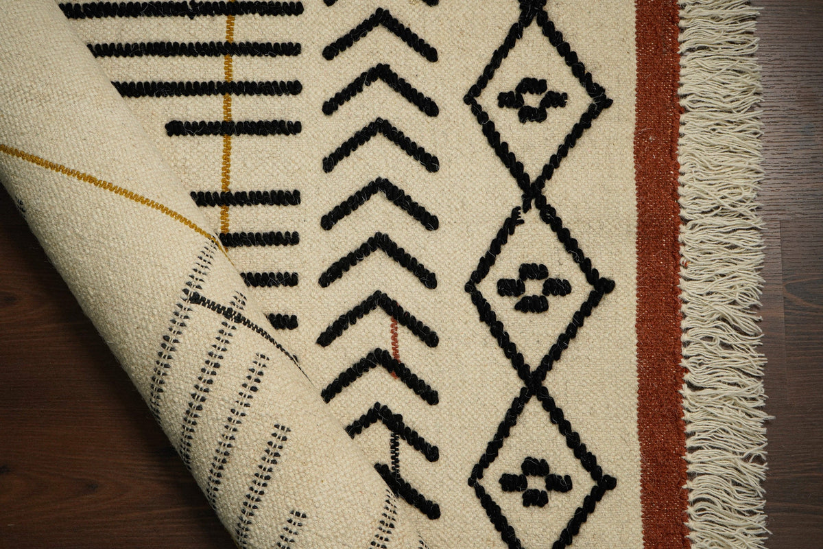 Ivory abstract rug styled in a bright living area