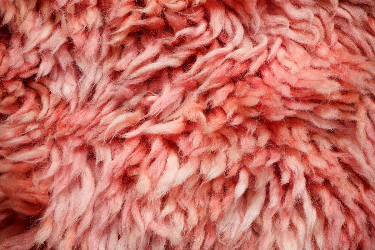 Pink shag rug styled in a bedroom setting