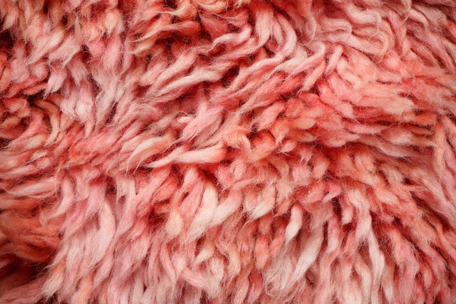 Pink shag rug styled in a bedroom setting