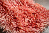 Close-up of pink shaggy wool pile texture