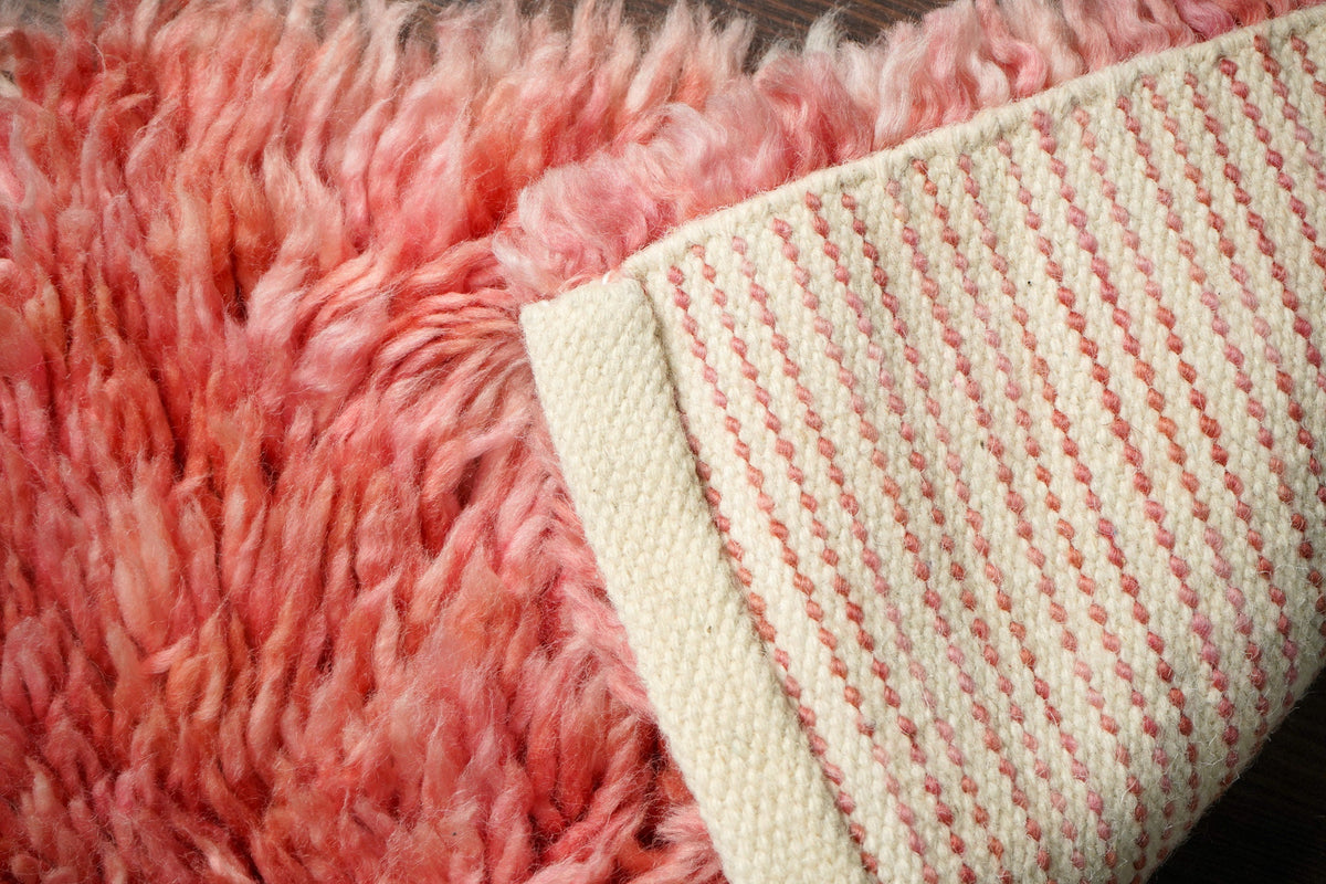 Pink rug corner detail showing shag pile