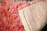 Pink rug corner detail showing shag pile
