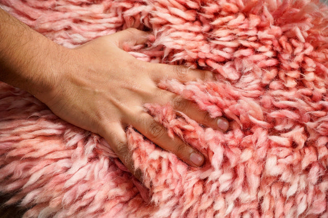 Pink shaggy wool rug flat view showing plush texture