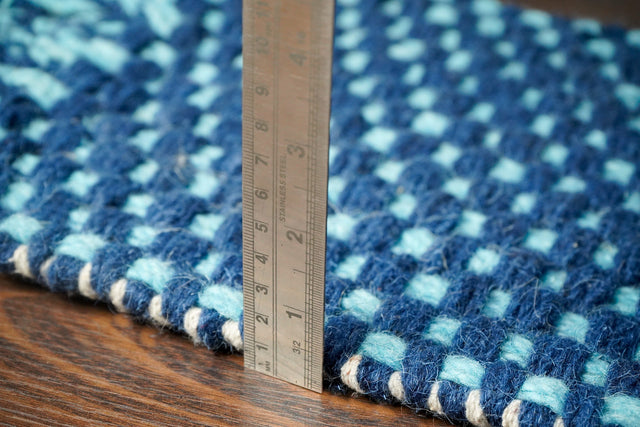 Blue wool rug styled in a living room setting