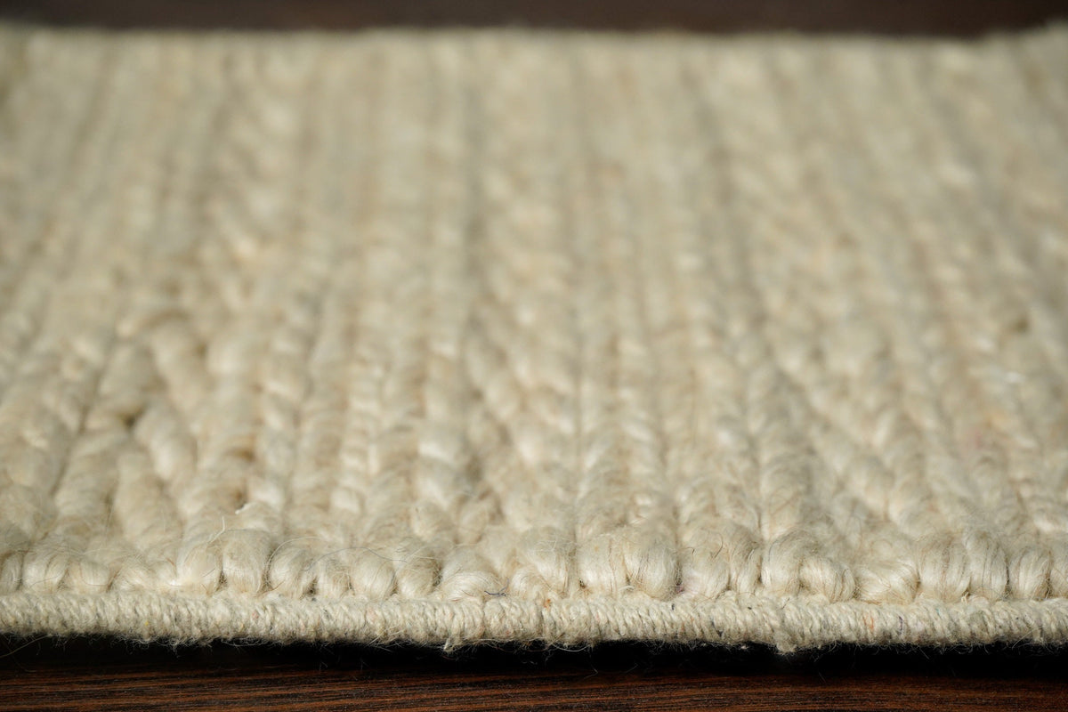 Ivory cream rug placed in a bedroom corner